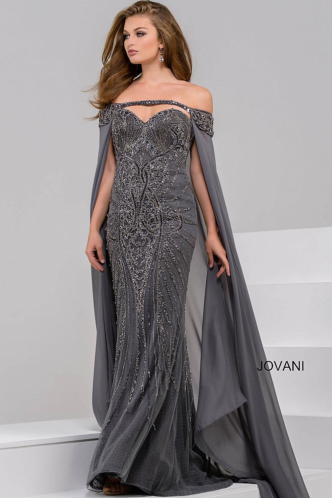 Jovani 45566 off the Shoulder Beaded Sweetheart Neck Dress 45566 Embellished tulle, lace underlay, form fitting, strapless, sweetheart neck, long off the shoulder chiffon cape beaded on top.