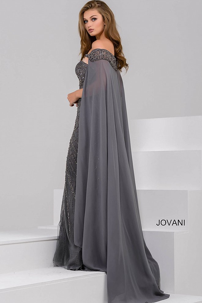 Jovani 45566 off the Shoulder Beaded Sweetheart Neck Dress 45566 Embellished tulle, lace underlay, form fitting, strapless, sweetheart neck, long off the shoulder chiffon cape beaded on top.