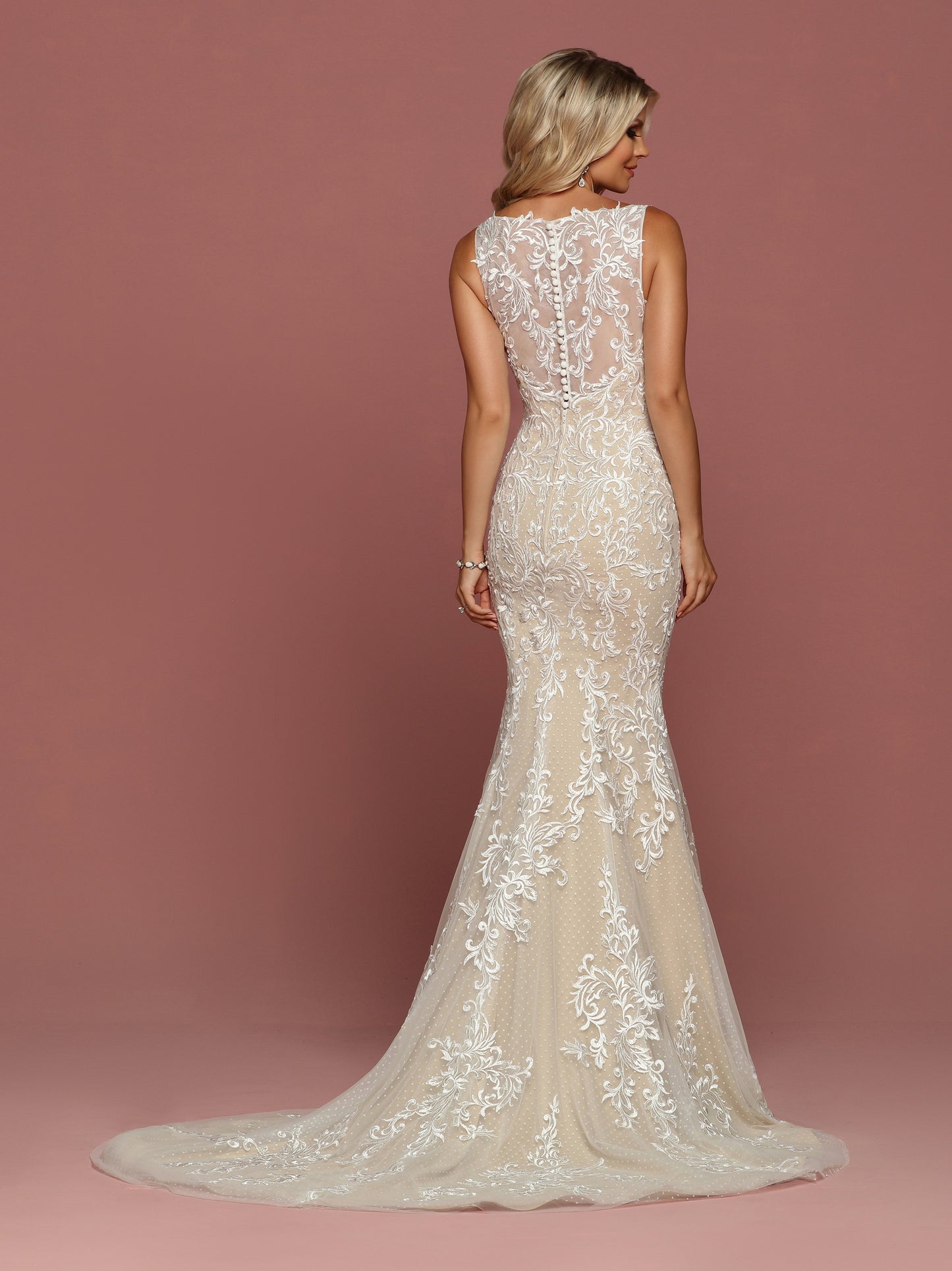 Davinci Bridal 50486 is a Fitted Mermaid Silhouette wedding dress. Featuring Point D' Esprit & Tulle. This Gown Has a V Neckline with Sheer lace straps leading to a sheer Illusion Lace back. Buttons line the back seam. Delicate lace covers this gown and cascades down into the trumpet skirt and train.  Available for 1-2 Week Delivery!!!  Available Sizes: 2,4,6,8,10,12,14,16,18,20  Available Colors: Ivory/Nude, Ivory/Ivory