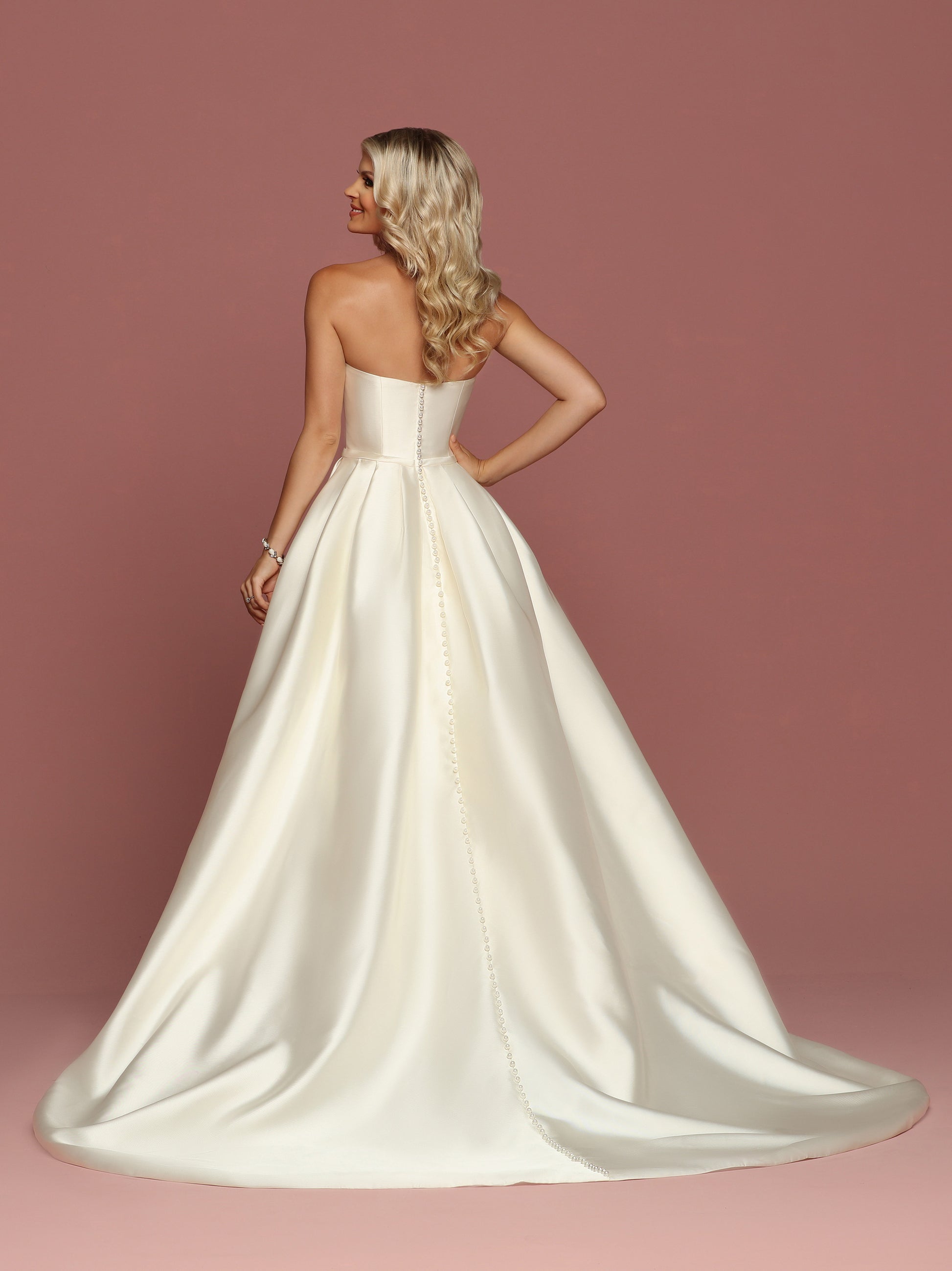 Davinci Bridal 50494 is a gorgeous Mikado Wedding Dress. Strapless Sweetheart neckline with a simple waist belt with bow. Full Pleated skirt has Pockets! Button line the entire back seam of the gown into the train.  Available for 1-2 Week Delivery!!!  Available Sizes: 2,4,6,8,10,12,14,16,18,20  Available Colors: Ivory