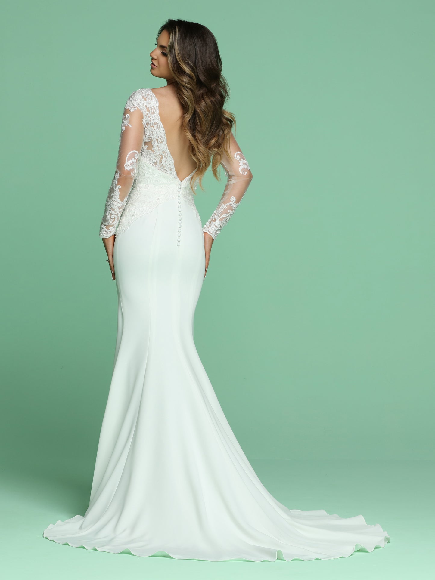 Davinci Bridal 50610 is a Beautiful Embellished Lace Sheer Long Sleeve Bridal Gown Featuring a V neckline with a Crystal & Beaded Fitted Lace Bodice and open V back with buttons running down the hips. Crepe Skirt flowing into a sweeping train.   Available for 1-2 Week Delivery!!!  Available Sizes: 2,4,6,8,10,12,14,16,18,20  Available Colors: Ivory  Available Sizes: 2-30