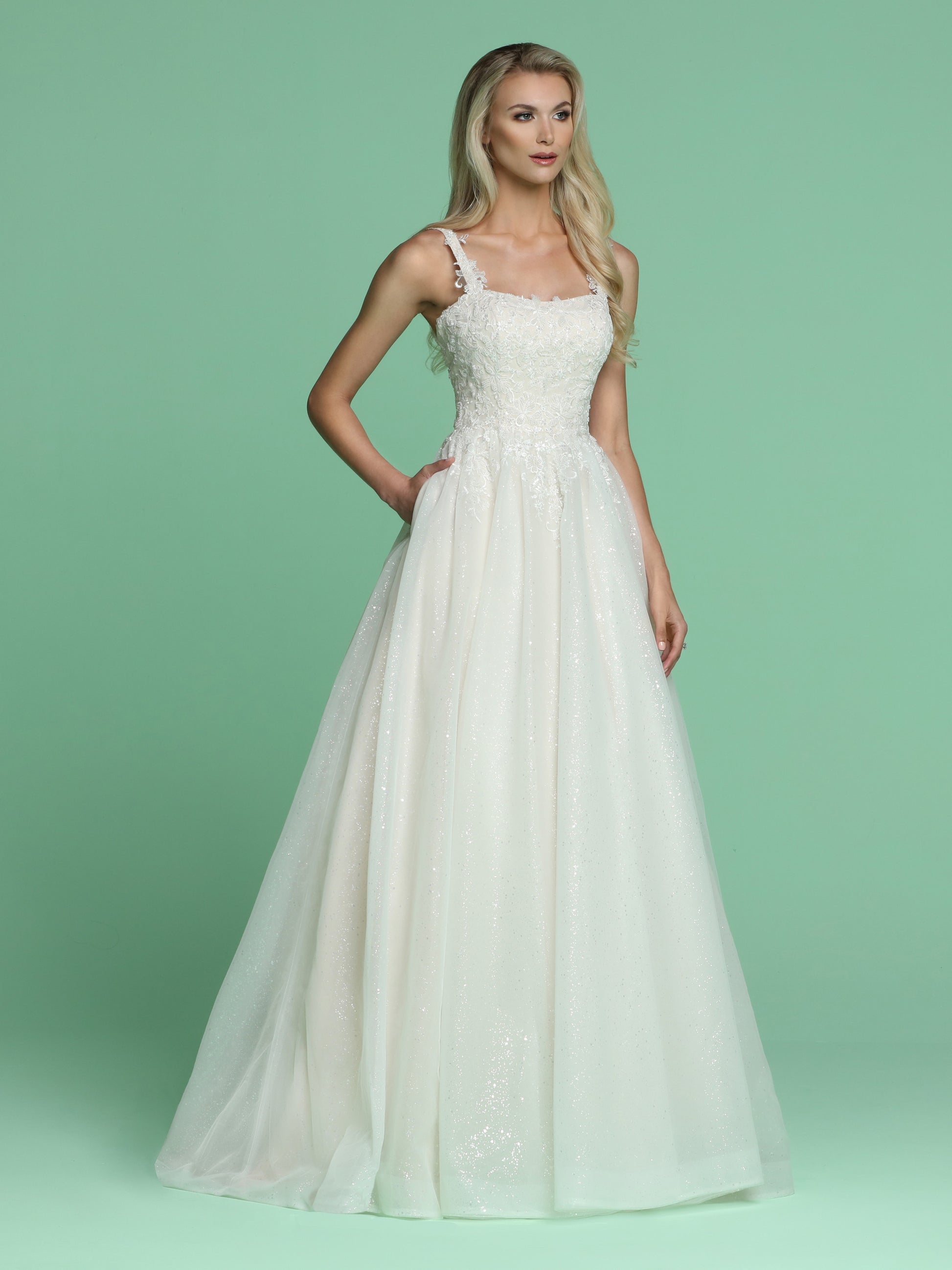 Davinci Bridal 50628 is a Beautiful Long Shimmering wedding dress. Featuring a Fitted bodice with embroidered lace cascading into a stunning Glitter shimmer tulle A line ball gown skirt with pockets and a lush train. Straps with embroidered lace cascading over. Available for 1-2 Week Delivery!!!  Available Sizes: 2,4,6,8,10,12,14,16,18,20  Available Colors: Ivory/Blush, Ivory/Ivory
