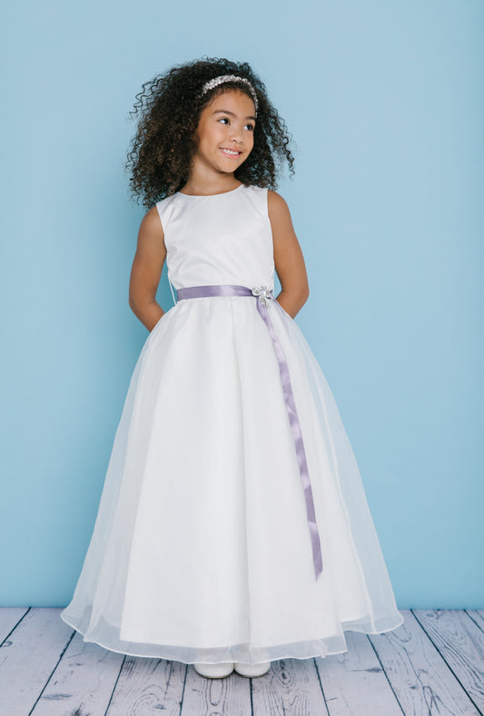 Rosebud Fashions Style 5109 is a full length sleeveless dress with a scoop neckline. The natural waist is accented with a satin ribbon and broach. Satin buttons cover the zipper. Flower Girl dress, First Communion  Available Sizes: 2,4,6,8,10,12,14,16  Available Colors: Ivory, White