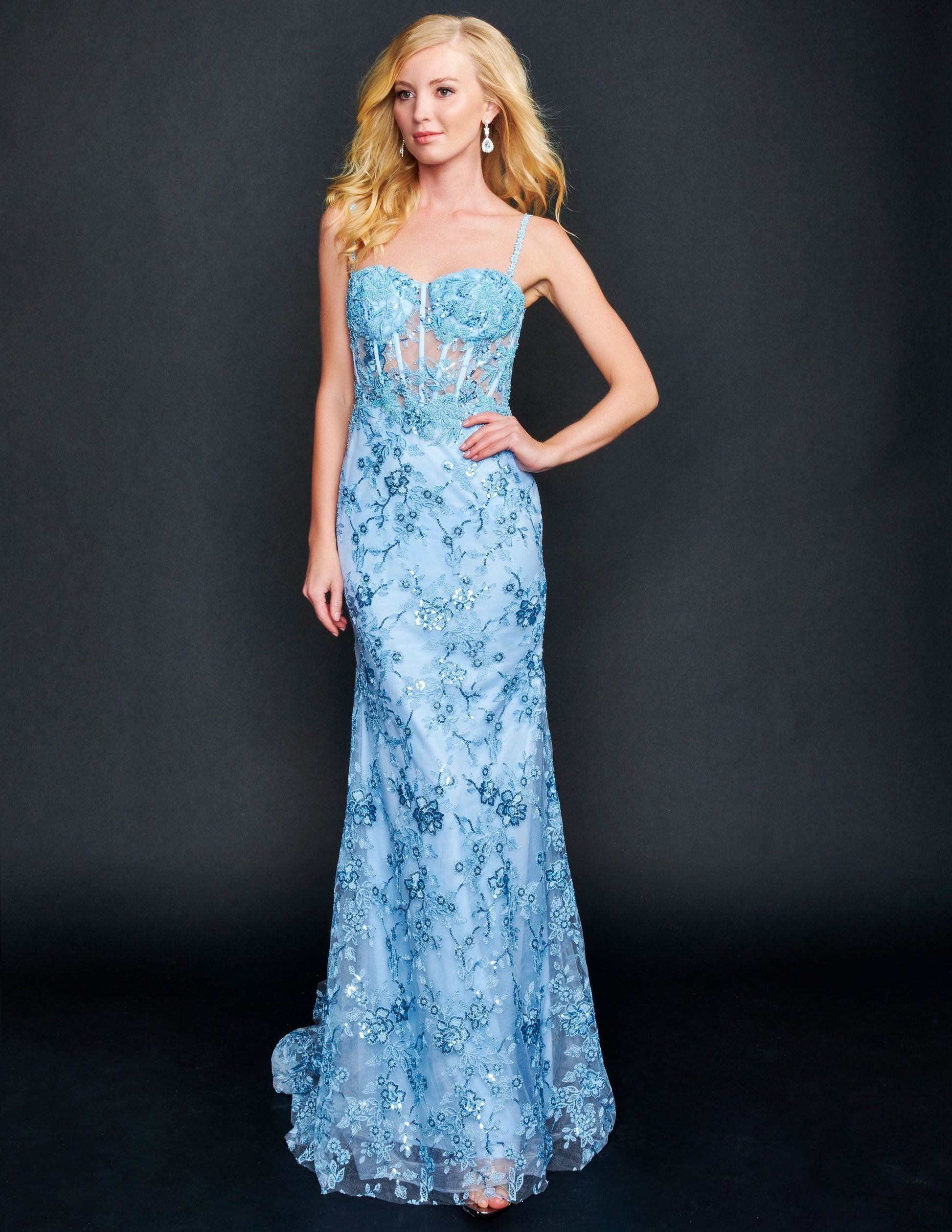 Nina Canacci 6556 Long sheer lace corset fitted bodice with a mermaid skirt and train. Embellished Prom Pageant Gown  Available Size-0-12  Available Color- Ivory, Baby Blue, Raspberry (Mauve)