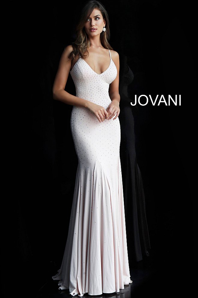 Jovani 63563 Crystal Rhinestone embellished jersey fitted evening gown.  V Neckline with spaghetti straps White jersey embellished fitted prom dress with v-neckline, sleeveless fitted bodice, spaghetti straps, and low v-back, floor length fitted skirt with flared end.  Style Code: 63563 Available Colors: black, blush, light-blue, navy, olive, red, white