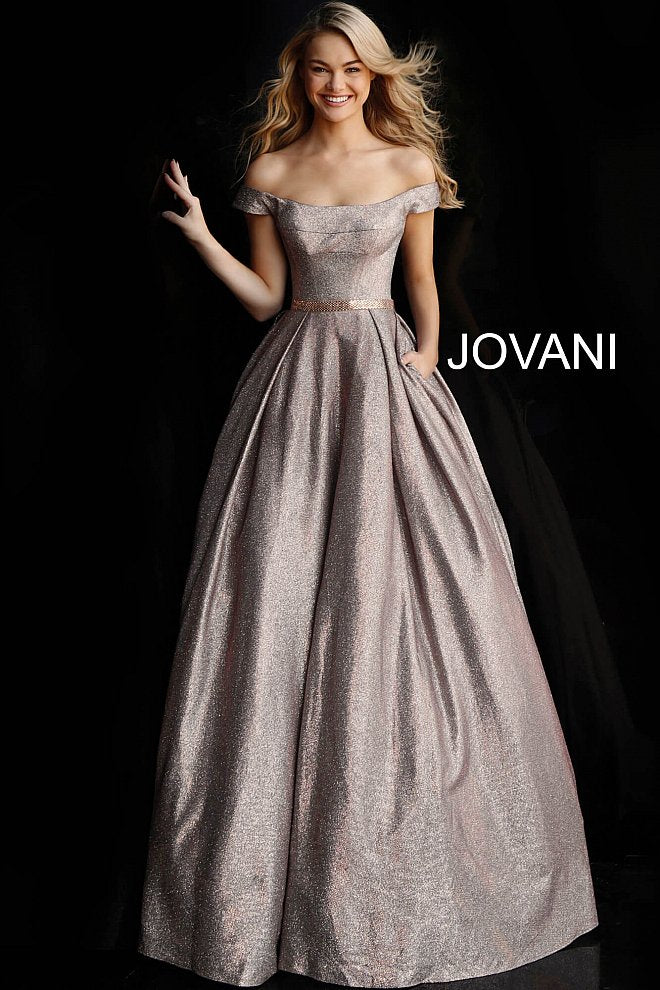 Jovani 66950  glitter prom dress ballgown with the off-the-shoulder sleeveless bodice, straight neckline, and beaded waist belt, floor-length pleated A-line skirt with side pockets. Makes a great evening ballgown. 