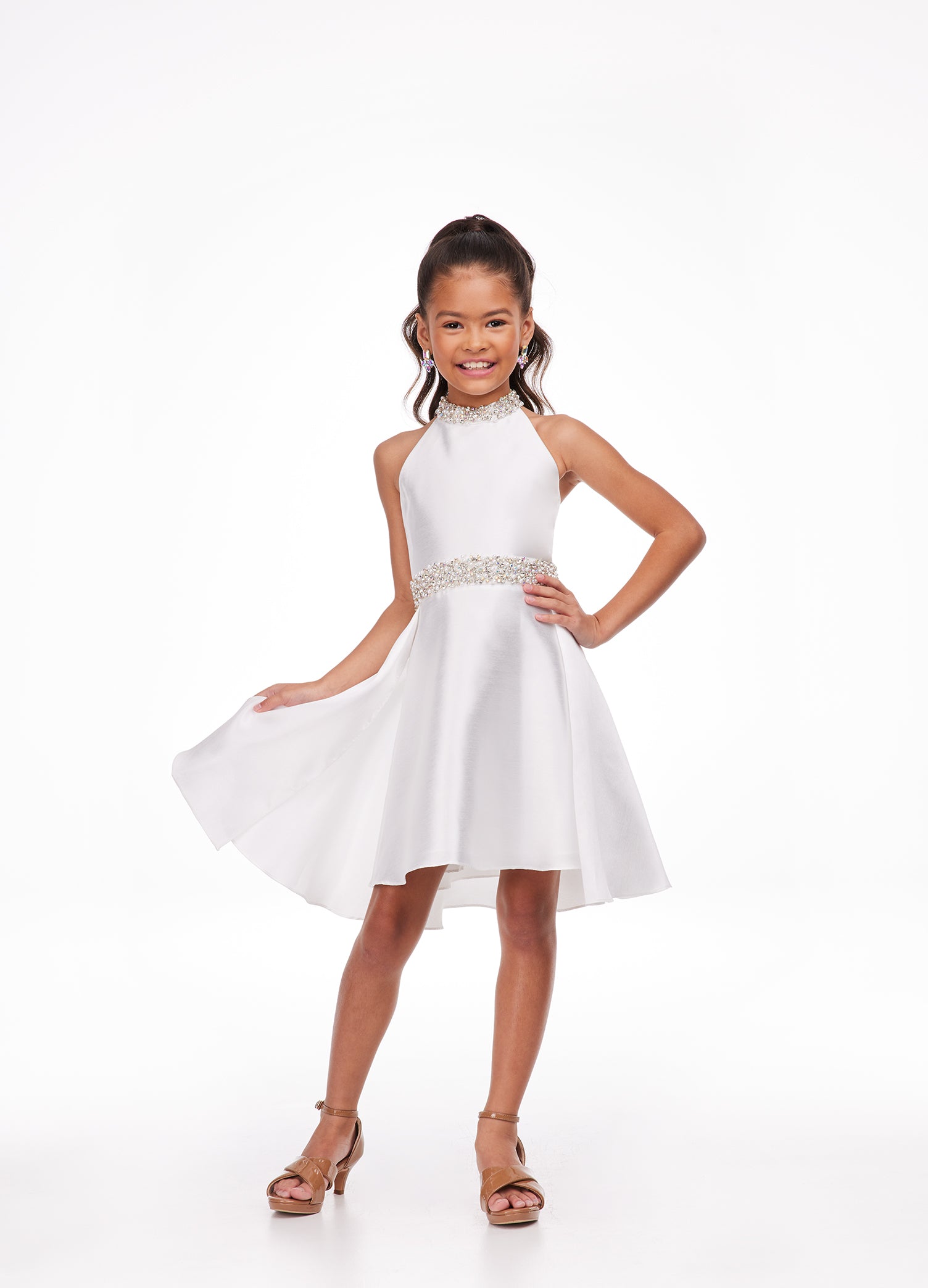 Ashley Lauren Kids 8103 Short Halter cocktail dress with overskirt Pageant Wear Stunning kids mikado cocktail dress featuring a crystal and pearl neckline and waist. The slight a-line skirt is completed with an overskirt for extra flare. Halter Neckline Crystal Beaded Neck & Belt A-Line Skirt Overlay Available Sizes: 4-16 Available Colors: Sky, White, Yellow, Orchid
