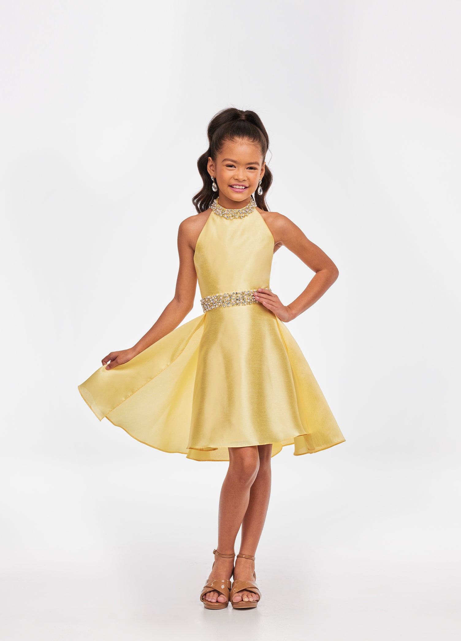Ashley Lauren Kids 8103 Short Halter cocktail dress with overskirt Pageant Wear Stunning kids mikado cocktail dress featuring a crystal and pearl neckline and waist. The slight a-line skirt is completed with an overskirt for extra flare. Halter Neckline Crystal Beaded Neck & Belt A-Line Skirt Overlay Available Sizes: 4-16 Available Colors: Sky, White, Yellow, Orchid