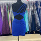 Amarra 87157 is a Short Fitted Rhinestone Embellished One Shoulder Formal Cocktail Dress. Featuring a Ruched Bodice & butt. Cutout open back with embellished straps. Perfect for Homecoming!  Available Sizes: 8  Available Colors: Royal Blue