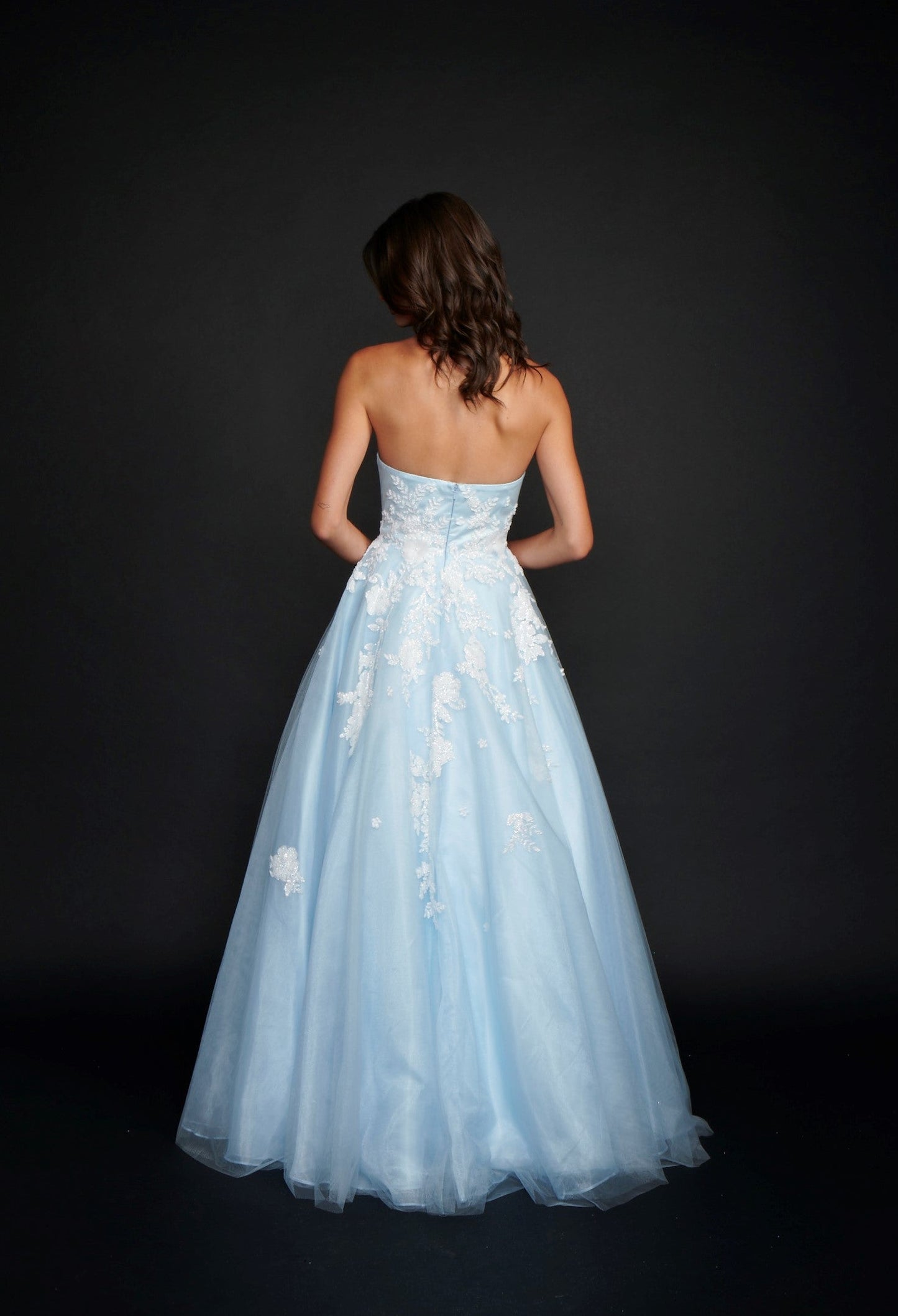 Nina Canacci 9137  This is a strapless ballgown with a sweetheart neckline and 3D floral appliques on the bodice and streaming down the dress. It is good for a Wedding dress or Prom Gown.   Available Size- 4-18  Available Color- Baby Blue, Ivory