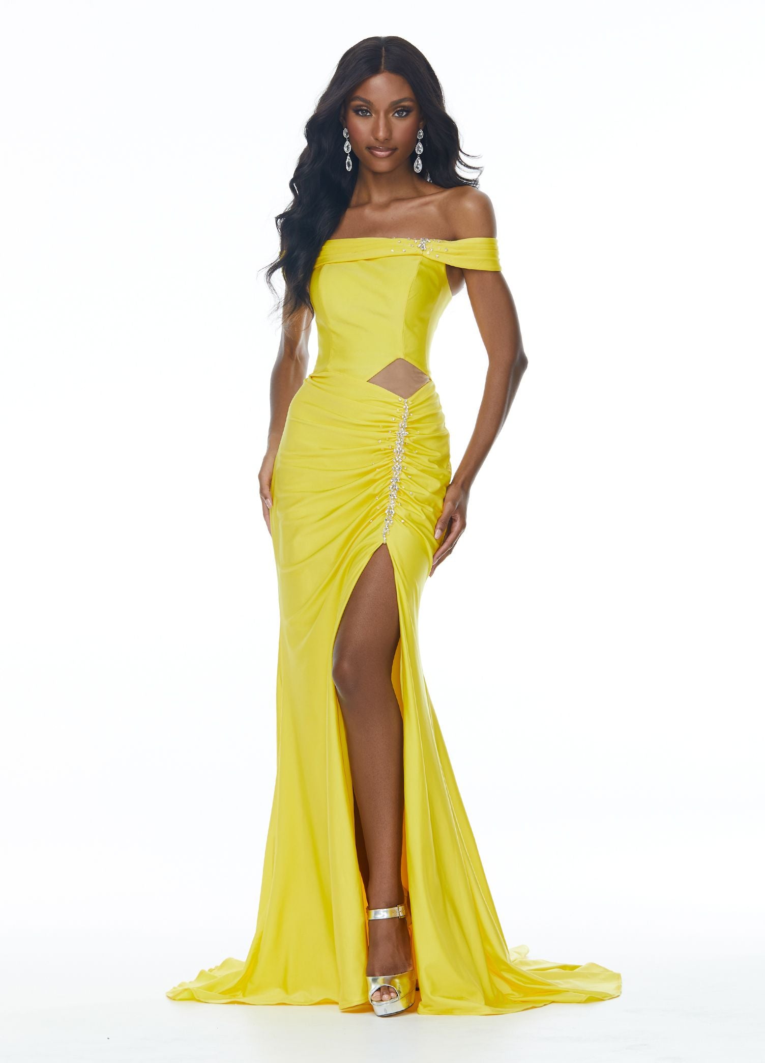 Ashley Lauren 11031 This jersey prom dress has a ruching along the off shoulder straps and waistline, crystal detailing, a modern cut out and lace up back. The skirt on this long pageant evening gown is complete with a left leg slit.  Colors  Yellow, Royal  Sizes  0, 2, 4, 6, 8, 10, 12, 14, 16  Off Shoulder Cut Out Slit Lace up Back