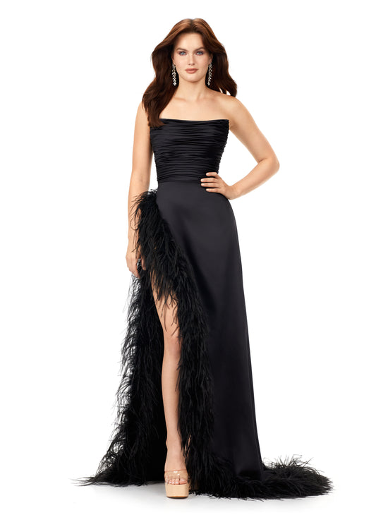 Ashley Lauren 11313 Black Prom, Pageant, Reception, Formal Evening Dress. We love a feather moment! This strapless satin gown features a ruched bodice giving way to a slight a-line skirt. The skirt is complete with a high right leg slit trimmed in feathers that continue to cascade down the hemline.