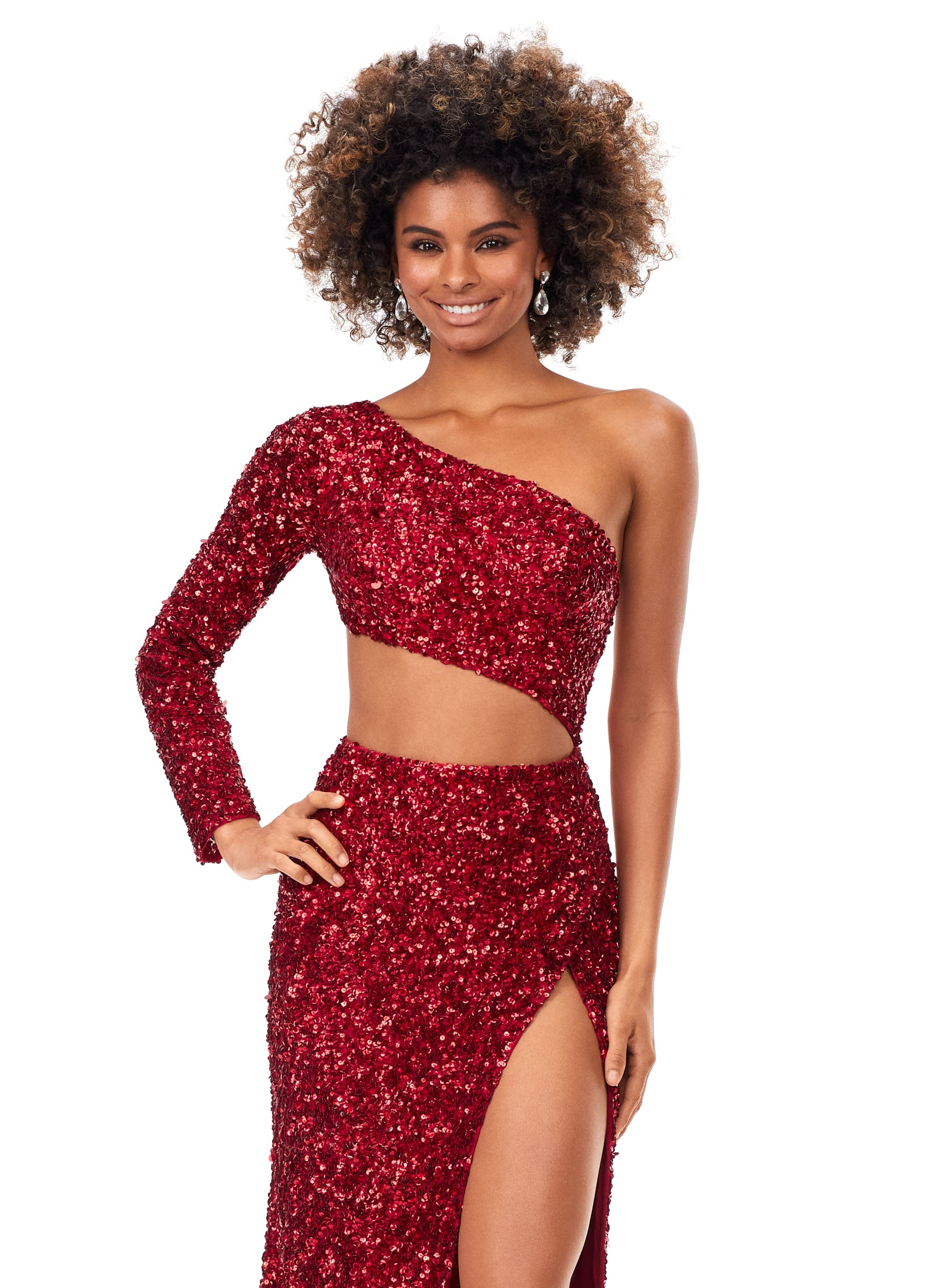 Ashley Lauren 11340 This sequin one shoulder gown features one sleeve and a shark bite cut out. The gown is complete with a left leg slit.