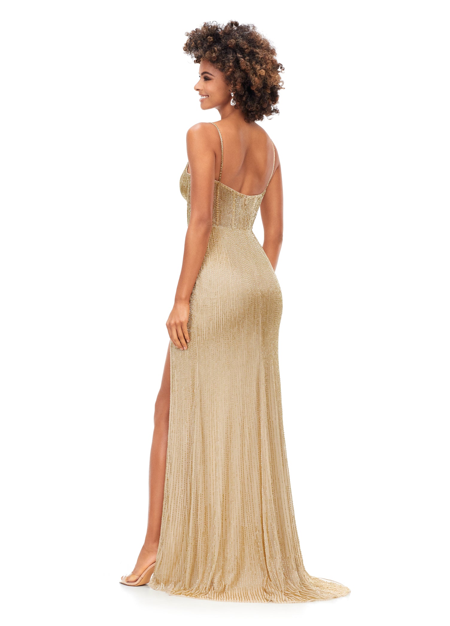 Ashley Lauren 11369 This Gold liquid beaded style features an exposed bustier that is sure to accentuate your curves. The look is complete with sweep train and left leg slit.