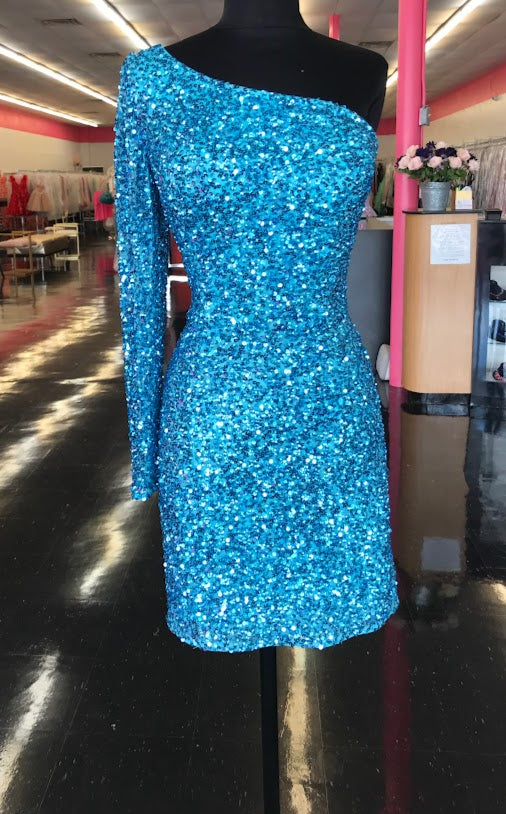 Ashley Lauren 4457 Cocktail Dress.  This is a perfect homecoming or pageant dress, pick your color.  The fitted dress is fully hand beaded sequins with one shoulder neckline and a sheer beaded long sleeve. This dress would make an excellent reception dress if you wanted sparkle at your wedding.   Colors:  Neon Blue  Sizes:  8