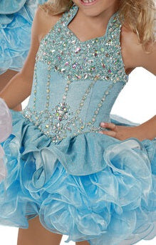 Ritzee Girls B282 is a glitter stretch shimmer Fabric material. Embellished top with AB Rhinestone Crystal Accents with a collar leading to an open cutout back. Lush Ruffle Layered Cupcake pageant Skirt. 282