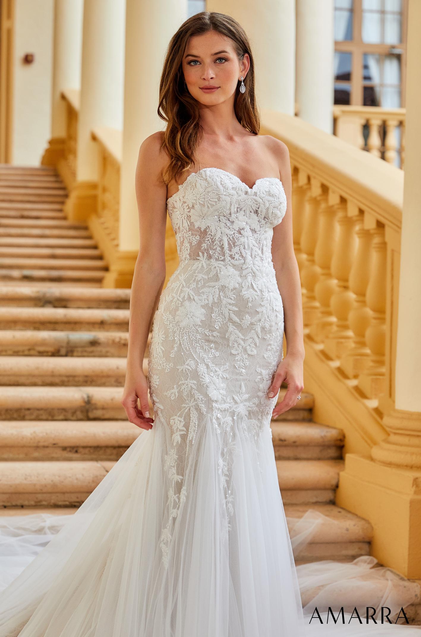 Amarra BELLA 84375 Sheer Beaded Mermaid Wedding Dress Off the shoulder Bridal Gown Featuring detachable shoulder straps that gracefully hang off the shoulders and beautiful lace embroidery throughout the bodice, Bella is sure to have you looking and feeling like a majestic beauty. The fitted waist hugs and highlights your curves, creating a beautiful hourglass silhouette.
