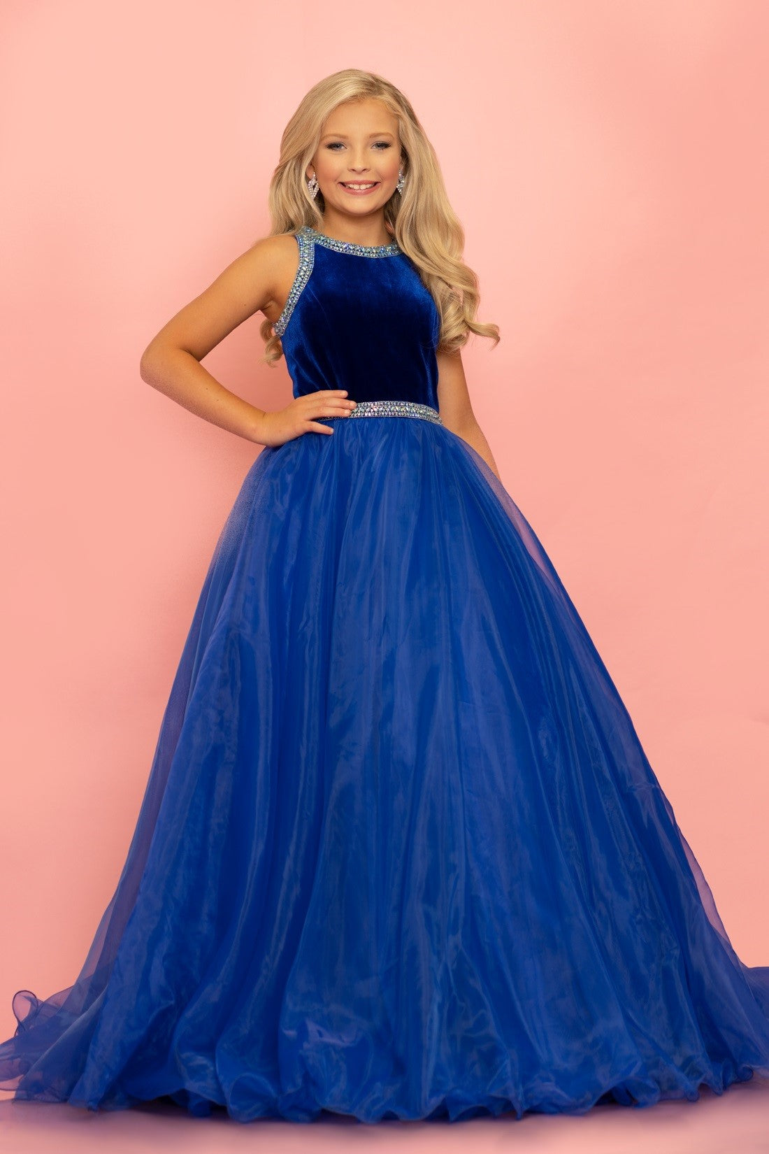 Sugar Kayne C124 by Johnathan Kayne is a stretch satin bodice girl pageant dress. Lush Organza Ballgown skirt. Crystal Embellished waist band and bodice edges. High Neck Gown with sweeping train.  Available Colors: Creamsicle, Royal  Available Size: 2-16