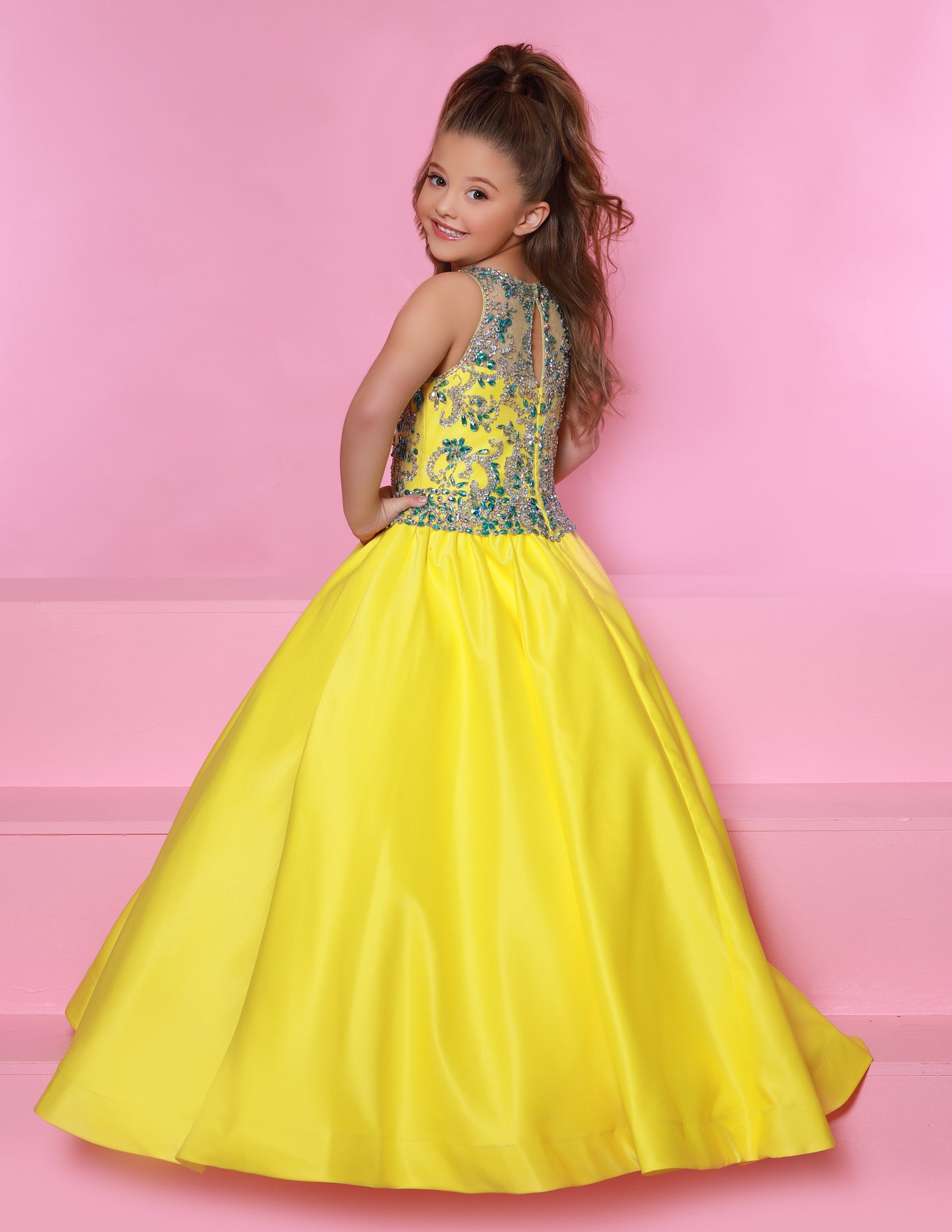Sugar Kayne C158 Is a long sating A Line Ballgown girls Pageant Dress. Featuring a fully embellished bodice with a sheer illusion high neckline.  Colors: Lemon/Aqua, White/Aqua  Sizes:  2-16  (Sizes 2-6 do not have bust cups, Sizes 8-16 will have preteen size bust cups)