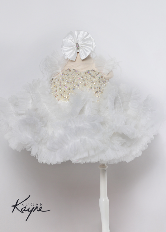 Sugar Kayne C217 Short Pleated Ruffle Cupcake Pageant Dress AB Crystal Pearl Bodice Corset. Have your little cupcake bring on all the charm in this stunning mesh gown accented with pearls. The corset back is the perfect addition as the little one grows!  Colors: White  Sizes: 0M, 12M, 18M, 24M, 2T, 3T, 4T, 5T, 6M, 6T  Fabric Mesh, Satin Lining