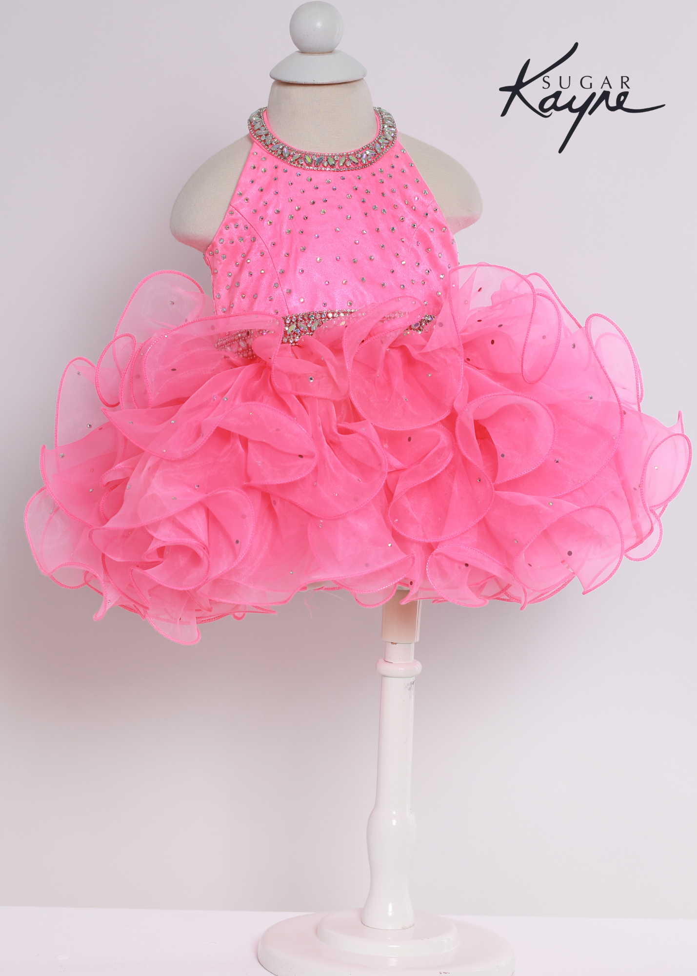 Sugar Kayne C220 Girls Baby Halter Cupcake Ruffle Pageant Dress Corset Formal Gown Have your little cupcake bring on all the charm in this stunning organza gown. The corset back is the perfect addition as the little one grows!  Colors: Bubblegum, Neon Orange, White  Sizes: 0M, 12M, 18M, 24M, 2T, 3T, 4T, 5T, 6M, 6T  Fabric Organza, Satin Lining