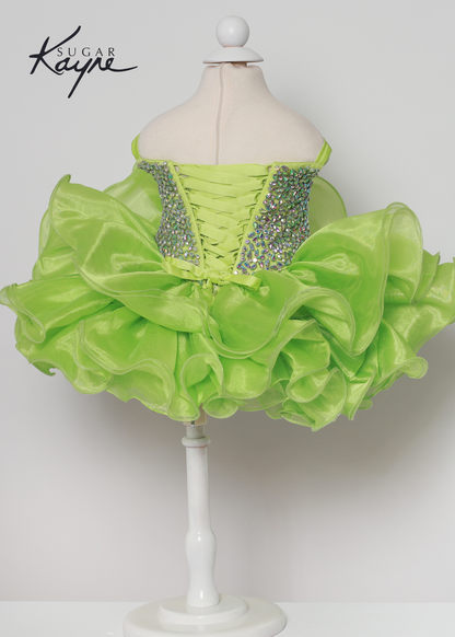 Add a touch of sparkle to your special occasion with the Sugar Kayne C226 Dress. It features intricate rhinestones and a corseted back for adjustable comfort, making it the perfect pageant gown for growing kids. The unique organza ruffles bring a delightful finish for a truly stunning look.  Sizes: 0M, 12M, 18M, 24M, 2T, 3T, 4T, 5T, 6M, 6T  Colors: Barbie Pink, Kiwi, Royal