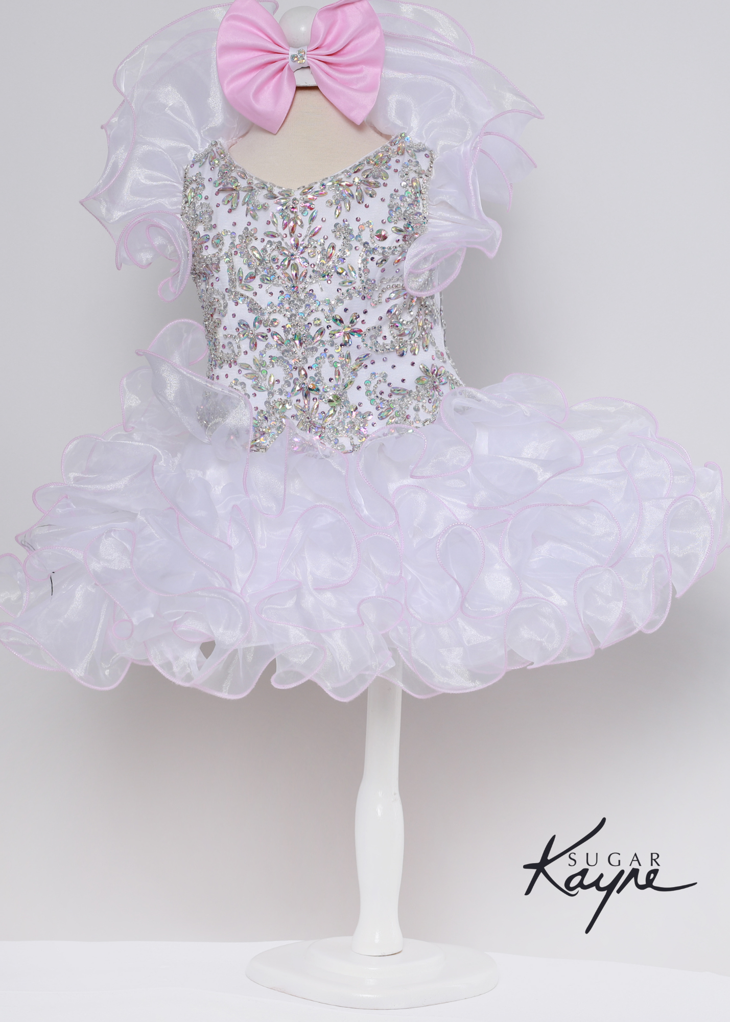 Sugar Kayne C227 Girls Baby Crystal Beaded Ruffle Sleeve Cupcake Pageant Dress Formal Have your little cupcake bring on all the charm in this stunning organza gown. The corset back is the perfect addition as the little one grows!  Colors: Baby Pink, White-Pink  Sizes: 0M, 12M, 18M, 24M, 2T, 3T, 4T, 5T, 6M, 6T  Fabric Organza, Satin Lining