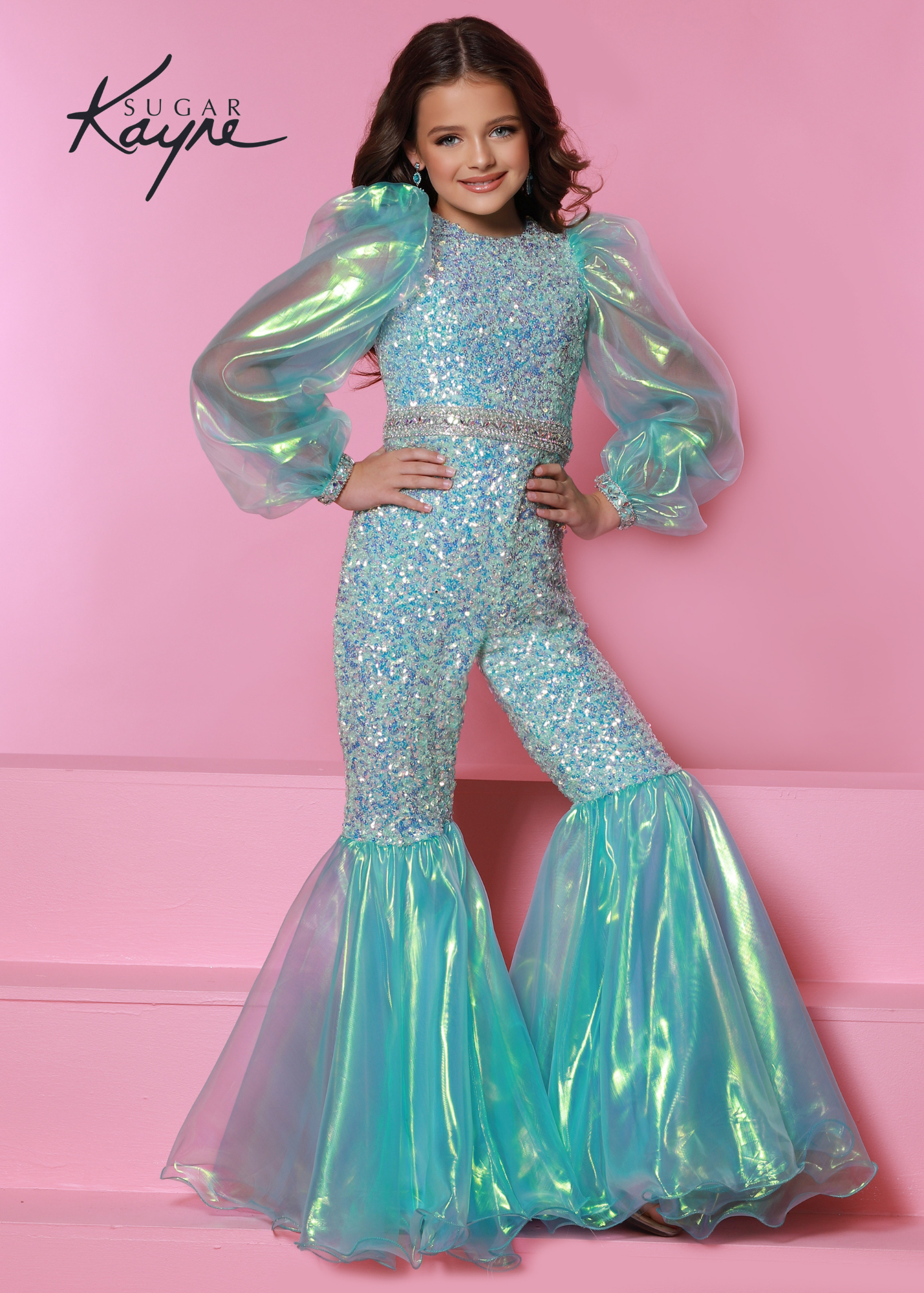 Sugar Kayne C307 Girls Sequin Jumpsuit Bell Bottom Long Sleeve Pageant Fun Fashion Shimmer Product Details Bring back the 70's with this fun fashion bell bottom jumpsuit. The sequin mesh adds the right amount of sparkle to make you glisten on the stage. The look is completed with the iridescent organza puff sleeves.  Colors: Aqua, Pink, White  Sizes: 2, 4, 6, 8, 10, 12, 14, 16  Fabric Sequin Mesh, Stretch Lining, Iridescent Organza