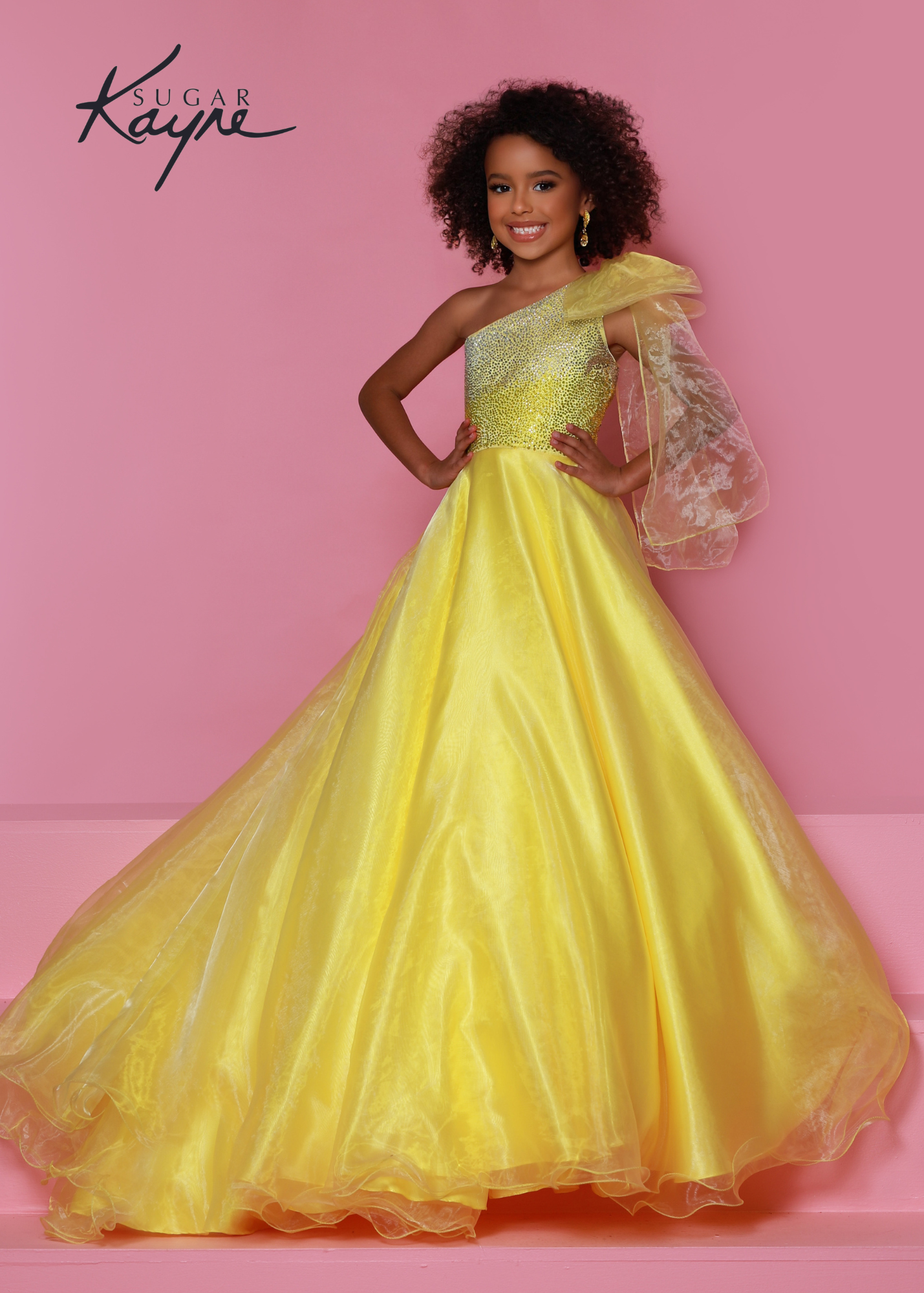 Sugar Kayne C310 Girls One Shoulder Bow A Line Shimmer Pageant Dress Crystal Gown  Go ahead and take a BOW in this lovely one-shoulder organza ballgown. The ombre beaded bodice brings all the dazzle!  Colors: Orange, Yellow, Blue  Sizes: 2, 4, 6, 8, 10, 12, 14, 16  Fabric Organza, Mesh, Satin Lining