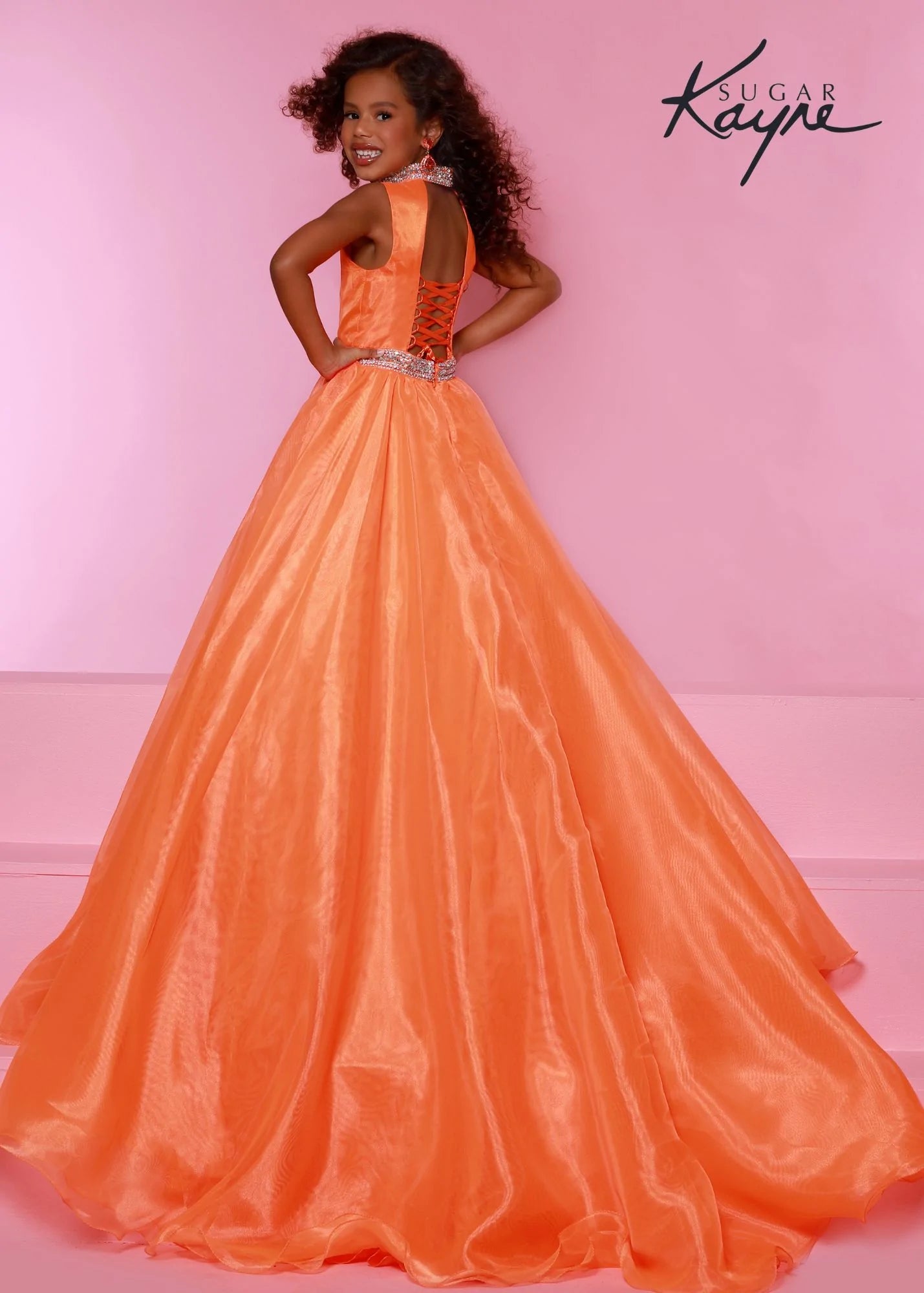 Sugar Kayne C317 Long Organza Girls A Line Pageant Dress High Neck Formal Gown Crystal Belt Simplistic but stunning! This organza ballgown features a hand-beaded collar and waist band to add a little sparkle to stun the crowd. The corset back is great as you grow! Open Back Corset  Colors: Barbie Pink, Carribbean, Ruby Red, Tangerine  Sizes: 2, 4, 6, 8, 10, 12, 14, 16  Fabric Organza, Satin Lining