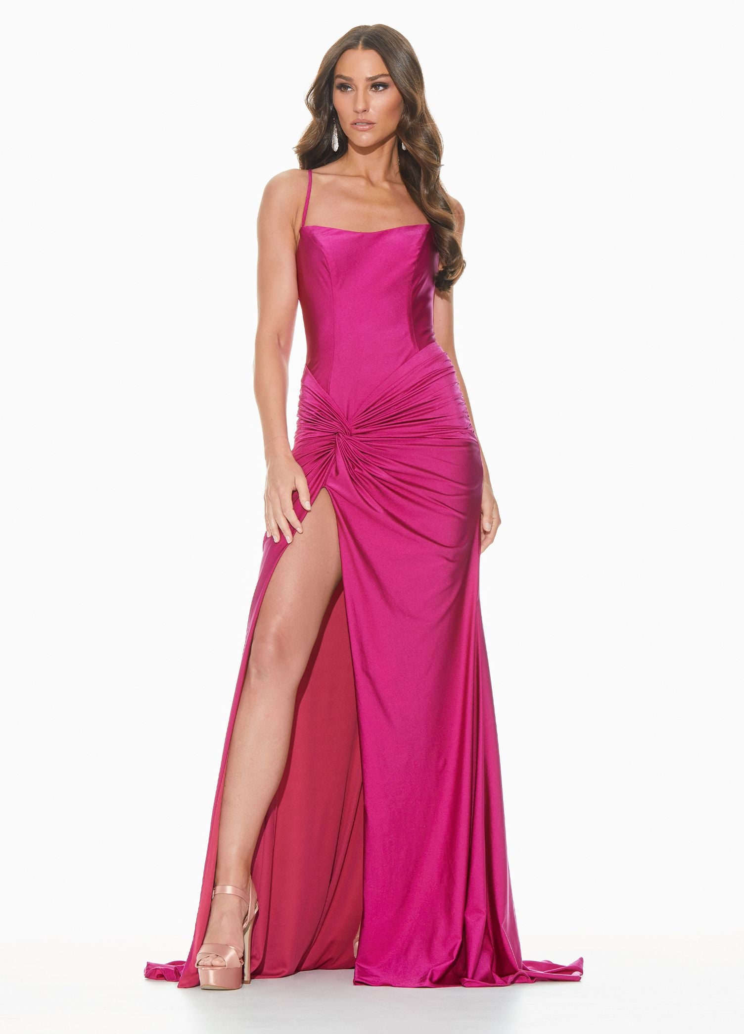 Ashley Lauren 11040 Wow in this chic evening gown with a lace up back and twist knot detail. The hip on this prom dress is adorned with a twist knot detail that gives way to a right leg slit. The skirt on this pageant dress is finished with a sweeping train.  Colors  Rose, Raspberry, Black, Royal  Sizes  0, 2, 4, 6, 8, 10, 12, 14, 16, 18  Spaghetti Straps Twist Knot Detail Slit Lace up Back Jersey