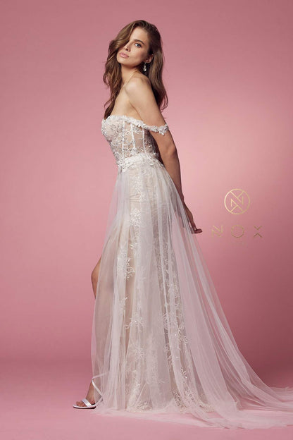 Nox Anabel E 441 OFF SHOULDER BOHO INSPIRED TULLE LAYERS A-LINE GOWN A romantic update to the traditional bohemian style, falls in love with this boho wedding dress with the empire waist by NOX ANABEL. This long dress features an off the shoulder sweetheart neckline on a fitted bodice adorned with tussle lace embellishments. It displays a thigh-high slit and uses tulle fabric that is perfect for a memorable wedding day.