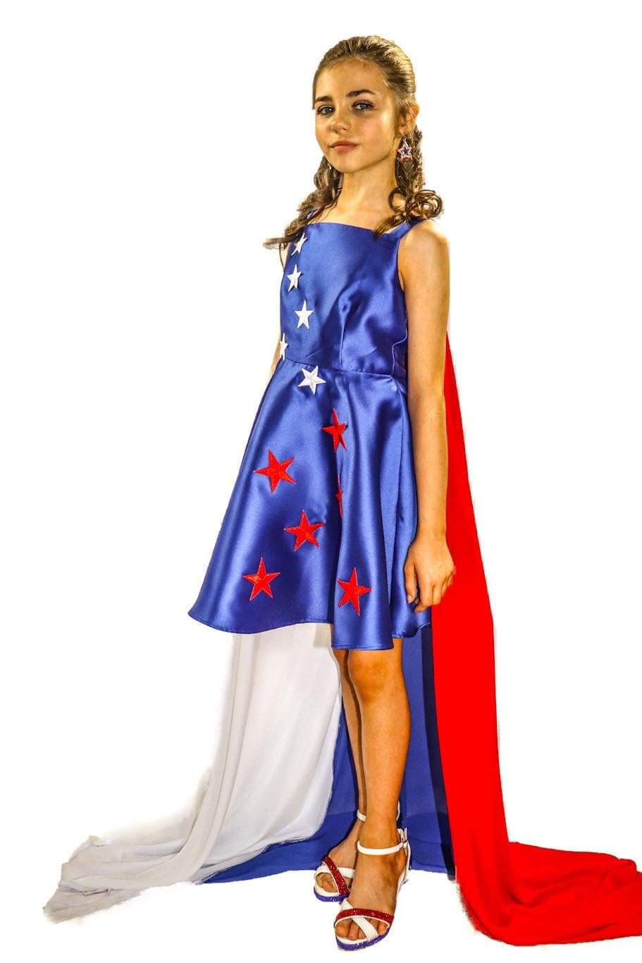 Marc Defang 5030 Red White & Blue Girls Pageant Fun Fashion Cape Detachable chiffon skirt/cape. Stars adorn he short a line dress. Perfect for Fun Fashion!  Available Sizes: 4-14  Colors: Red/White/Blue