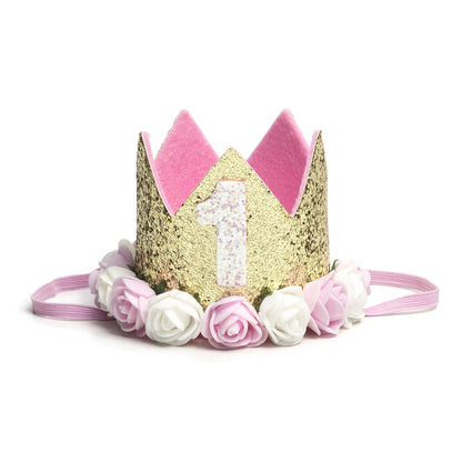 Sweet Wink -  The Gold Blush #1 Flower Crown is the perfect addition to any first birthday! This fun and festive flower crown makes a great birthday present or is an adorable way to dress up your little one for a cake smash, birthday party, or Instagram photo. Item description:  Gold glitter crown White glitter #1 Pink and ivory flowers trim the base of the crown Light pink felt lining inside the crown and on the bottom of the crown to ensure comfort and softness on the child's head Light pink elastic to se