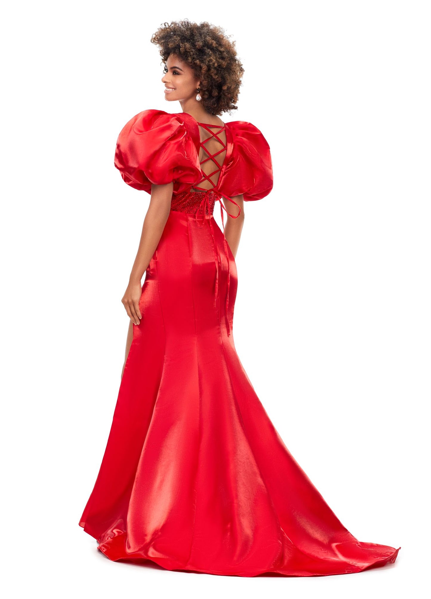 Ashley Lauren 11379 Shine in this v-neckline dress that features oversized puff sleeves. The waistband is embellished with scattered heat set stones and is complete with a lace-up back. V-Neckline Oversized Puff Sleeves Fitted Skirt Shimmer Satin COLORS: Aqua, Black, Red