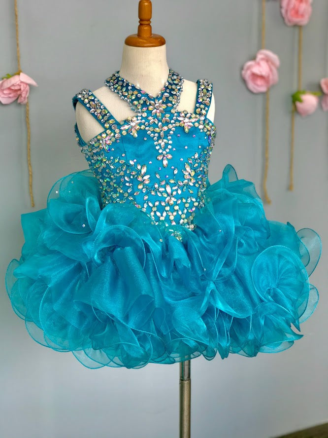 Ritzee Girls B279 is a short Layered ruffle cupcake Pageant Dress. Featuring a multi strap high neckline with AB Crystal Rhinestone Embellishments along the Top & Bodice. Open Cutout embellished back. Stunning stage gown!  Available Sizes:  2  Available Colors: Jade