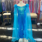 Marc Defang 8099K is a KIDS long pageant formal wear jumpsuit that is made of sequins and has off the shoulder straps.  The straps are attached to a cape with feathers at the shoulders.  Wow the crowd at your next pageant.  Available colors:  Pink, Turquoise, White, Black, Royal  Available sizes:  4,5,6,7,8,9,10,11,12,13,14   Please allow 30 Days for Delivery or a rush fee is available!