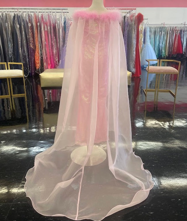 Marc Defang 8099K is a KIDS long pageant formal wear jumpsuit that is made of sequins and has off the shoulder straps.  The straps are attached to a cape with feathers at the shoulders.  Wow the crowd at your next pageant.  Available colors: Pink  Available sizes:  8
