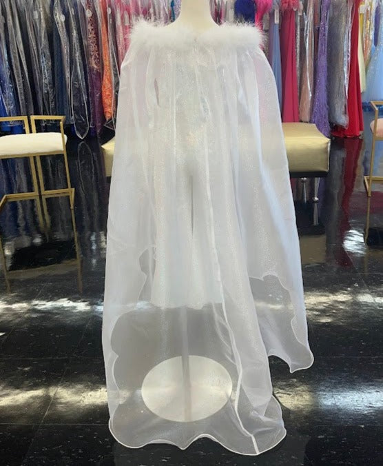 Marc Defang 8099K is a KIDS long pageant formal wear jumpsuit that is made of sequins and has off the shoulder straps.  The straps are attached to a cape with feathers at the shoulders.  Wow the crowd at your next pageant.  Available colors:  White  Available sizes:  4