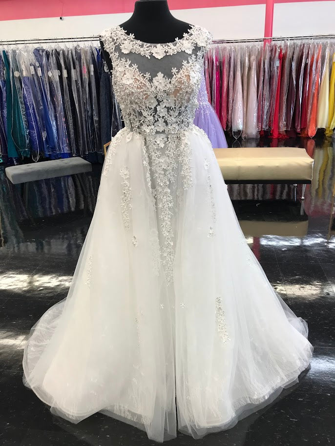 Johnathan Kayne Bridal B105 3D Flower Lace Bridal Gown Overskirt Wedding  Dress High Neck Stunning lace lush overskirt with a sheer high neckline. 3D Floral embellished lace. Bridal Gown, Wedding Dress  Available Color: Blush, Ivory  Available Sizes: 00,0,2,4,6,8,10,12,14,16,18,20,22,24  Chantilly Lace, Mesh, Organza