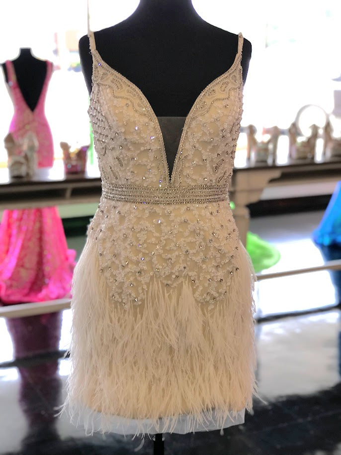Jovani 04624 is a short fitted formal cocktail dress. Featuring a Plunging V Neckline with A Beaded & Embellished bodice and Crystal rhinestone waist belt lines. Elegant Feathers accent the hips and short skirt. Great for a wedding reception or Red Carpet Gown! Versatile enough for Prom, Homecoming & More! 