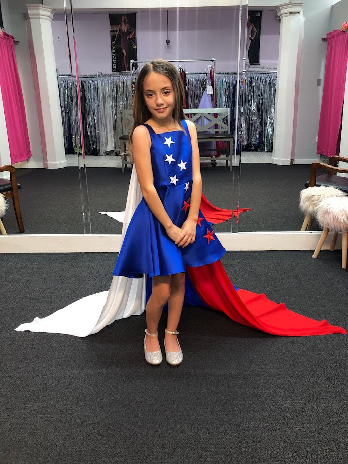 Marc Defang 5030 Red White & Blue Girls Pageant Fun Fashion Cape Detachable chiffon skirt/cape. Stars adorn he short a line dress. Perfect for Fun Fashion!  Available Sizes: 4-14  Colors: Red/White/Blue