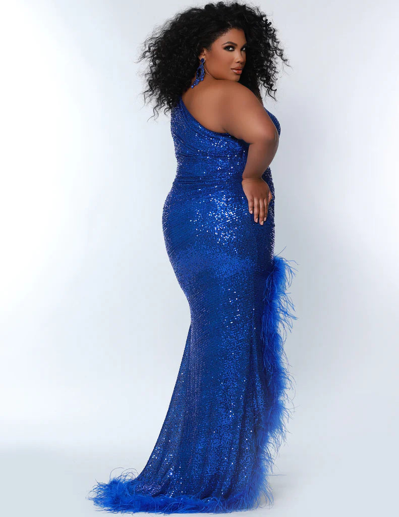 The Sydney's Closet JK2303 is a stunning fitted one-shoulder maxi dress designed for plus sizes. Crafted from a sequined fabric with a feathered trim, this dress features a side slit for a dramatic silhouette. The JK2303 is sure to make a statement at prom events.  Sizes: 10-24  Colors: Cobalt, Firecracker, Jet