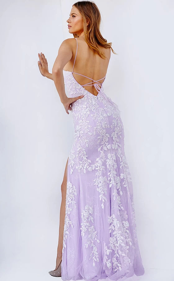 Jovani JVN06660 - JVN 06660 is a long fitted Lace formal evening gown. This Backless prom dress with a lace up corset back closure features floral lace appliques embellished with crystal rhinestones over a lace layer. Fit & Flare Silhouette with a lush sweeping train and a wide thigh slit.
