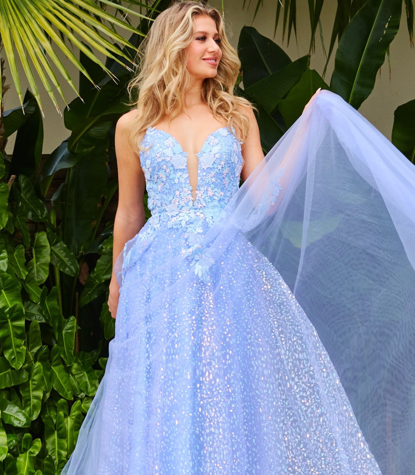 JVN07252A_FRONT-perriwinkle-blue-prom-dress-A-Line-sparkleJVN07252 Periwinkle Prom Dress.  Do you love flowers and periwinkle?  Then this prom dress is for you.  It is an A line dress with sequin underlay long skirt.  The bodice has a low v neckline with sheer courtesy panel.  The bodice is covered in floral appliques that stream down the dress.  Available color:  Periwinkle  Available sizes:  00-24 