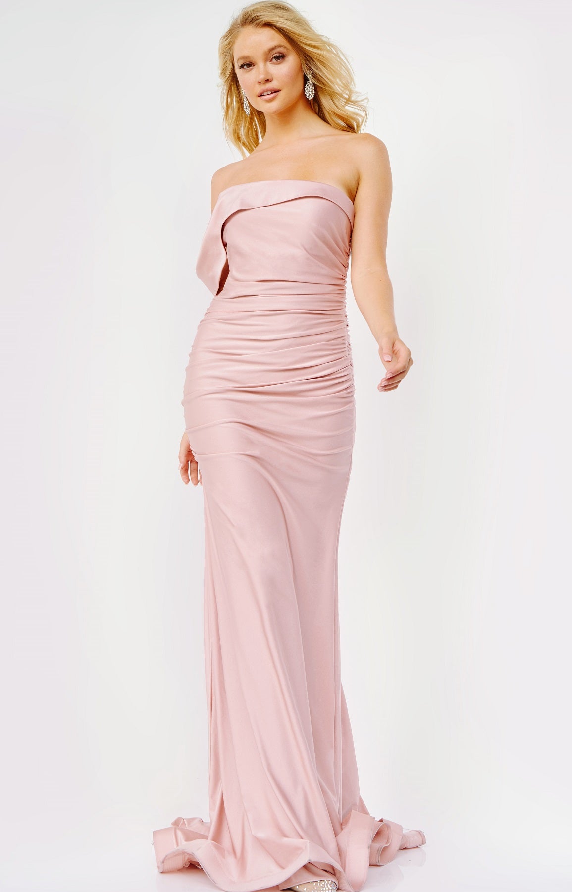 JVN07640 This a JVN by Jovani Prom Dress features a beautiful ruched fit and flare silhouette with an asymmetrical neckline and one right side off the shoulder strap. A good choice for any formal event or bridesmaids. Blush