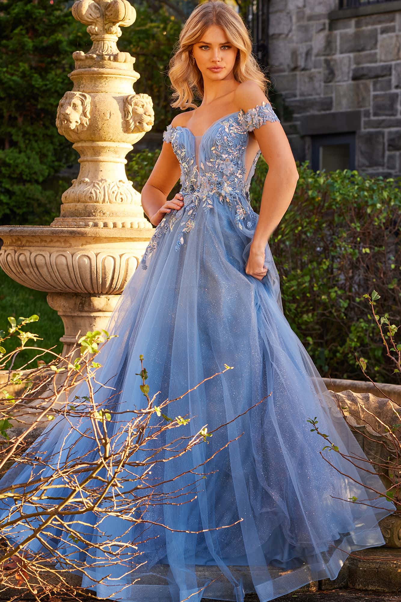 Jovani's JVN23698 Prom Dress provides a regal aesthetic with its glitter underlay and intricate floral accents adorning the fitted bodice and voluminous A line floor-length skirt, guaranteeing you will sparkle.  Colors:  Mauve, Sky Blue