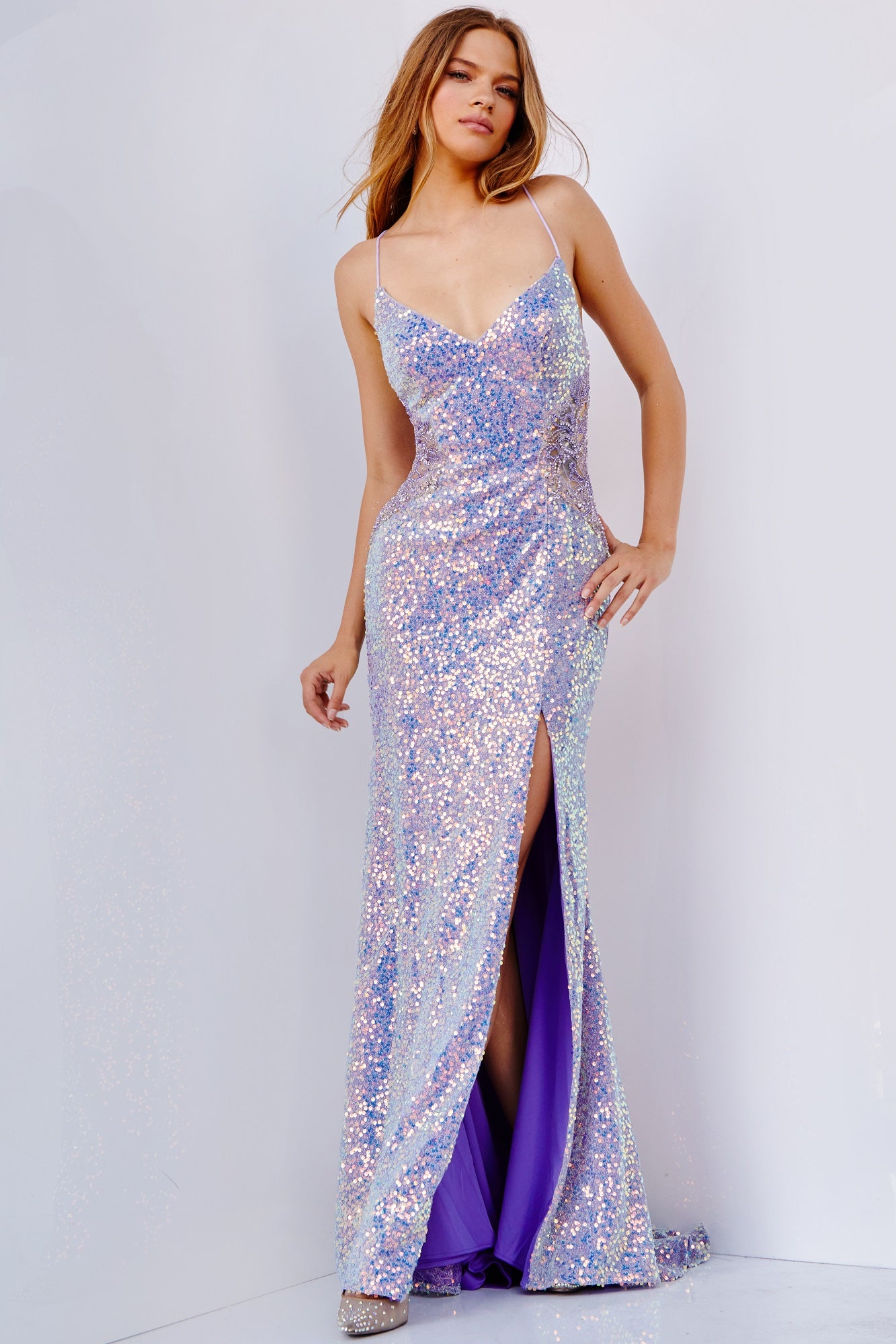 JVN24010 Iridescent sequin prom dress, form fitting silhouette, floor length skirt with high slit and sweeping train, sleeveless bodice with embellished sheer sides, spaghetti straps over shoulders, V neck, open tie back.