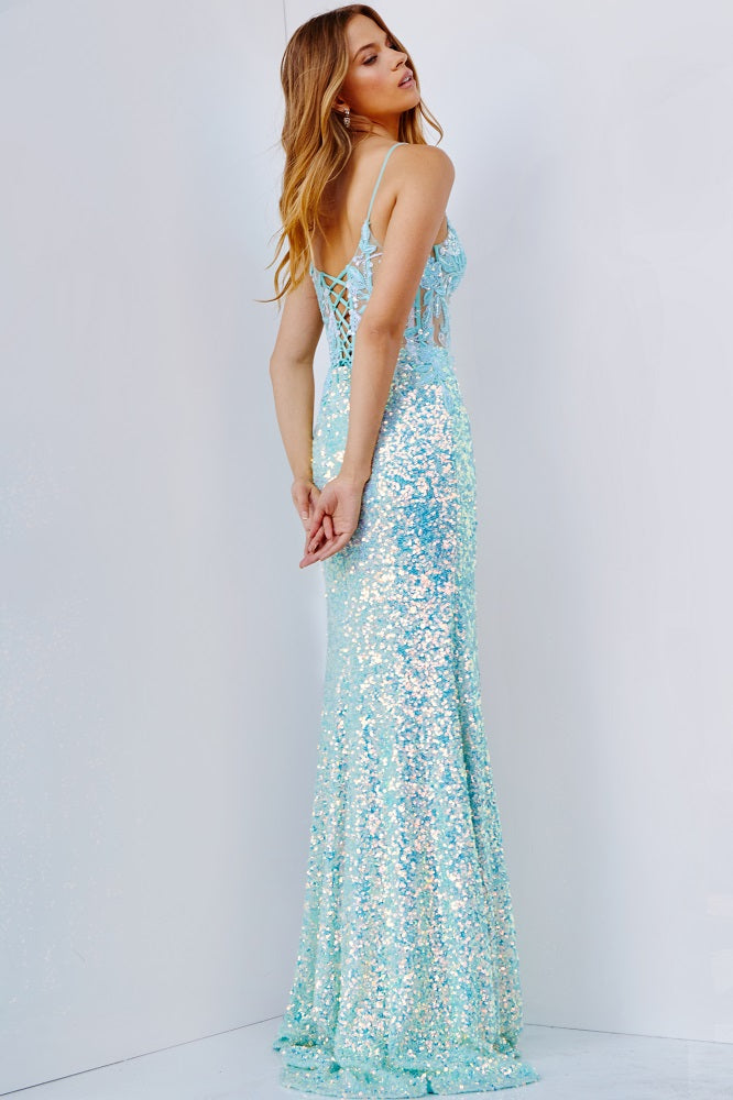 This JVN by Jovani prom dress style 24299 features a floor-length skirt with a high slit, an illusion fitted bodice and intricate embroidery, complemented by a lace-up back. This stunning design is available in Aqua and Pink.