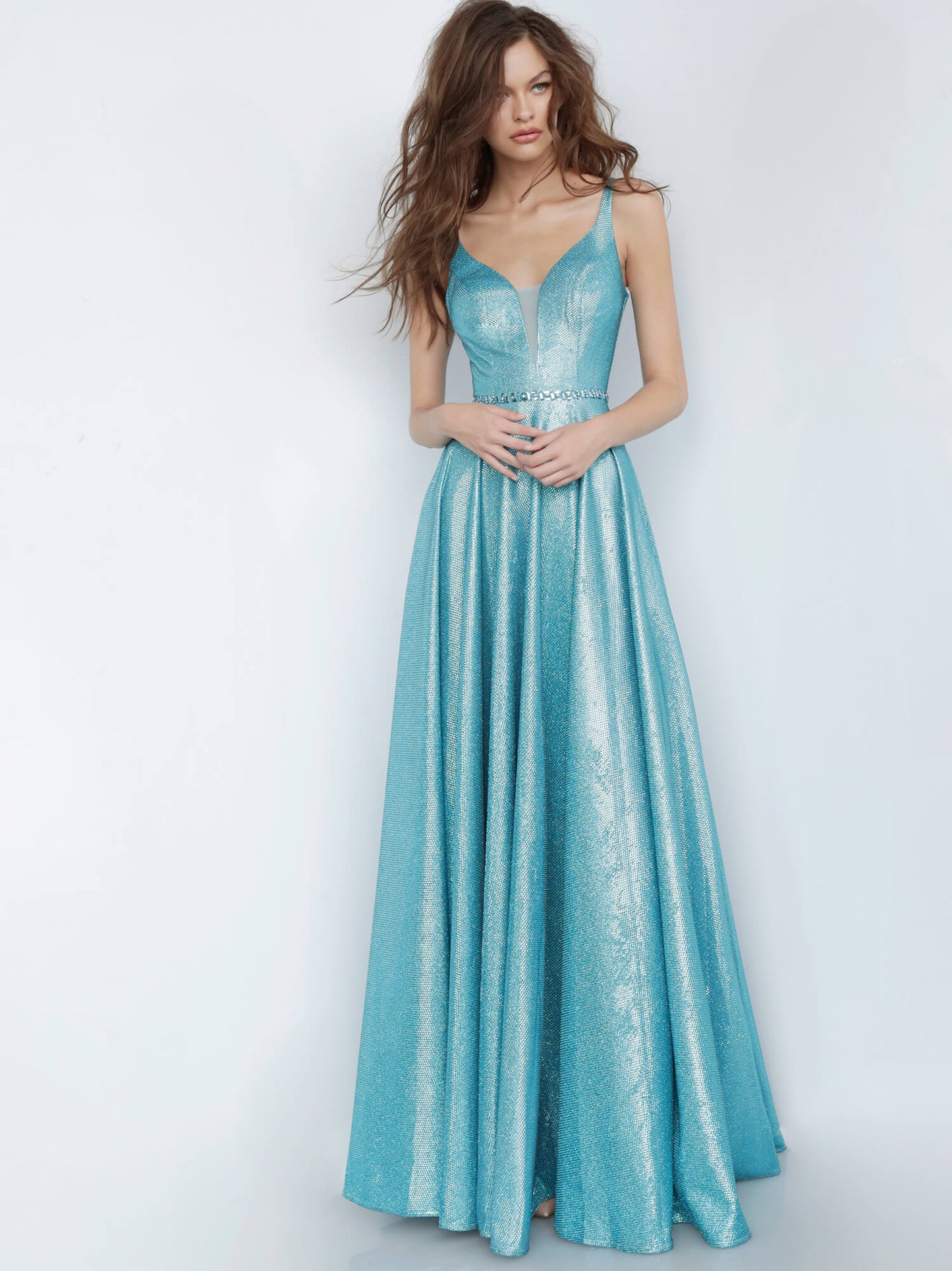 JVN67050 peacock metallic prom dress with a plunging mesh insert neckline, sleeveless fitted bodice, and v-back, embellished waist belt and floor-length pleated flowy skirt evening gown pageant dress.